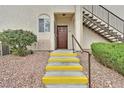 Inviting entrance with stairs leading to a cozy unit, complemented by neat landscaping and a welcoming door at 1830 N Buffalo Dr # 1029, Las Vegas, NV 89128