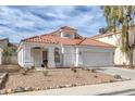 Charming single-story home with a red tile roof, white exterior, and desert landscaping at 239 Highgate St, Henderson, NV 89074