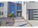 Modern home featuring a minimalist design, desert landscaping, and a welcoming front entrance at 2827 Richmar Ave, Henderson, NV 89074