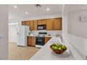 Well-lit kitchen with a clean white countertop, wooden cabinets, and modern appliances at 2832 Goldcreek St, Henderson, NV 89052
