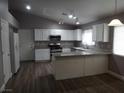 Bright kitchen features white cabinetry, granite countertops, stainless steel appliances, and new flooring at 3507 Pointe Vedra Ct, Las Vegas, NV 89122