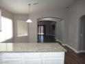 Spacious kitchen with granite countertops island and a seamless view into living areas of the home at 3507 Pointe Vedra Ct, Las Vegas, NV 89122