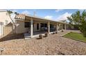 Relaxing backyard with a covered patio, well-maintained landscaping, and room for outdoor activities at 3561 Yorba Linda Dr, Las Vegas, NV 89122
