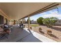 Enjoy the outdoors on this covered patio with a seating area and views of the backyard and desert landscaping at 3561 Yorba Linda Dr, Las Vegas, NV 89122