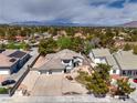 An aerial view of a two-story home featuring a large driveway and desert landscaping at 3710 E Oquendo Rd, Las Vegas, NV 89120