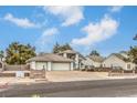 A two-story home with a three-car garage and a well-manicured front yard at 3710 E Oquendo Rd, Las Vegas, NV 89120