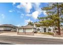 Attractive home featuring a three-car garage, manicured landscaping, and a welcoming front entrance at 3710 E Oquendo Rd, Las Vegas, NV 89120