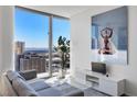 Bright living room with a comfortable gray couch and a scenic city view at 3722 Las Vegas Blvd # 2204, Las Vegas, NV 89158