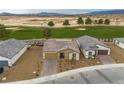Aerial view of a single-story home with neutral tones and manicured landscaping in a residential neighborhood at 4096 E Cactus Canyon Dr, Pahrump, NV 89061
