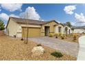 A charming single-story home with a brick driveway, desert landscaping, and a two-car garage at 4096 E Cactus Canyon Dr, Pahrump, NV 89061