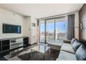 Bright living room featuring a sleek sofa, large windows, and city views at 4381 W Flamingo Rd # 2608, Las Vegas, NV 89103