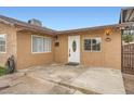 Inviting front porch with stucco walls and a white front door with decorative oval window at 442 Republic St, Henderson, NV 89015