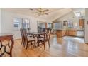 Dining room with hardwood floors, a vaulted ceiling, and a view of the kitchen at 5016 Roswell St, Las Vegas, NV 89120