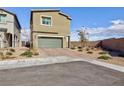 Two-story home featuring a two-car garage with a paved driveway at 5204 Sunstone Mesa Dr, Las Vegas, NV 89166