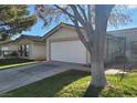 Charming one-story home with a well-maintained lawn, a driveway, and an attached two-car garage at 5709 Goldmount Ave, Las Vegas, NV 89107