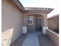 Inviting front entrance with a covered porch and desert landscaping at 6143 Majestic Wind Ave, Las Vegas, NV 89122