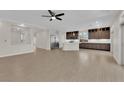 Spacious, light-filled room featuring modern cabinets, stainless appliances, and expansive neutral-toned tile flooring at 6325 Carmel Creek Ave, Las Vegas, NV 89139