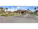 Spanish Trail gated entrance with beautiful stone pillars, mature landscaping, and a paved brick entrance at 7566 Spanish Bay Dr, Las Vegas, NV 89113