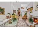 Elegant living room with high ceilings, a fireplace, and stylish furnishings at 7889 Harbour Towne Ave, Las Vegas, NV 89113