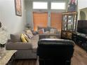 Inviting living room featuring plush sofas, hardwood floors, natural light, and stylish decor at 8396 Yamhill St, Las Vegas, NV 89123