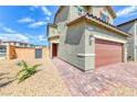 Two-story home featuring a brick driveway, attached two-car garage, and desert landscaping at 8502 Torozo Ave, Las Vegas, NV 89149