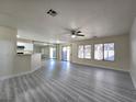 Bright and airy living room featuring wood-look flooring and sliding doors to the patio at 9662 Allison Ranch Ave, Las Vegas, NV 89148