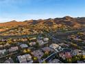 Wide aerial of a luxury community set against a desert mountain backdrop at 10 Greely Club Trl, Henderson, NV 89052