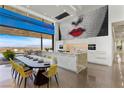 Gourmet kitchen featuring island, modern appliances, and dining space with city views at 11 Cloud Chaser Blvd, Henderson, NV 89012