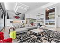Stylish living room boasts modern art, comfortable seating, and abundant natural light at 11 Cloud Chaser Blvd, Henderson, NV 89012