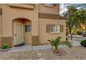 Charming home featuring low-maintenance landscaping, with an arched entrance way and a decorative security door at 11159 African Sunset St, Henderson, NV 89052