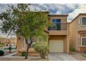 Attractive home with a balcony, attached garage, and desert landscaping at 11159 African Sunset St, Henderson, NV 89052