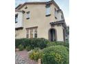 Attractive two-story townhome featuring arched entryway, landscaped front yard, and neutral color scheme at 11489 Belmont Lake Dr # 106, Las Vegas, NV 89135