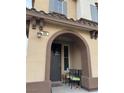 Inviting front porch featuring an arched entry, seating, and stylish decor at 11489 Belmont Lake Dr # 106, Las Vegas, NV 89135