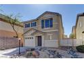 Attractive two-story home showcases a well-maintained front yard with rock features and blue shutters at 12045 Yarrow Ridge Ct, Las Vegas, NV 89183
