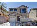 Charming two-story home with a front yard featuring decorative rock landscaping and blue shutters at 12045 Yarrow Ridge Ct, Las Vegas, NV 89183