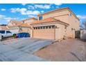 Charming two-story home showcasing its neutral color palette, tile roof and attached two-car garage at 1312 Pacific Terrace Dr, Las Vegas, NV 89128