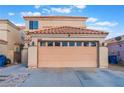 Charming home displaying its neutral color palette, tile roof and attached two-car garage at 1312 Pacific Terrace Dr, Las Vegas, NV 89128