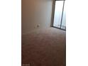 Carpeted bedroom showcasing a large sliding glass door to an enclosed patio at 2021 San Simeon St, Las Vegas, NV 89108