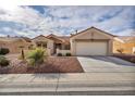 This lovely single-story house showcases a terra cotta roof and easy-care desert landscaping with an attached two car garage at 2345 Hot Brook Point St, Las Vegas, NV 89134