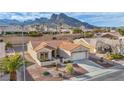 Inviting single-story house features a terra cotta roof and desert landscaping, set against a backdrop of majestic mountains at 2345 Hot Brook Point St, Las Vegas, NV 89134