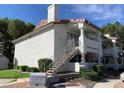 Exterior of an apartment building with white stucco and red tiled roofs at 2724 Otter Creek Ct # 101, Las Vegas, NV 89117