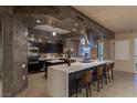 Contemporary kitchen with dark wood cabinets, a spacious white countertop island, and stainless steel appliances at 2777 Paradise Rd # Ph 3001, Las Vegas, NV 89109