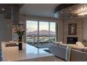 Open-concept living area with kitchen, dining and city views, fireplace, and comfortable seating at 2777 Paradise Rd # Ph 3001, Las Vegas, NV 89109