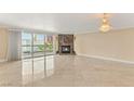 Spacious living room with marble fireplace, chandelier, tile flooring, and balcony access at 2857 Paradise Rd # 601, Las Vegas, NV 89109