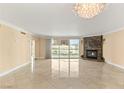 Open living room showcasing tile flooring, a marble fireplace, chandelier, and a bright balcony at 2857 Paradise Rd # 601, Las Vegas, NV 89109
