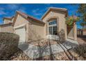 A charming single-story home with desert landscaping, a two-car garage, and an inviting entrance with brick accents at 3756 Prairie Orchid Ave, North Las Vegas, NV 89081