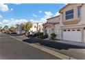 Townhouse community with well-maintained landscaping and street parking at 4012 Cape Sand Dr, Las Vegas, NV 89108