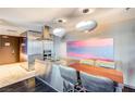 Sleek, modern kitchen featuring stainless steel appliances, a dining area, and stylish pendant lighting at 4381 W Flamingo # 2201, Las Vegas, NV 89103