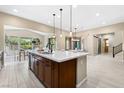 Spacious kitchen featuring a center island with a sink, stainless steel appliances, and an open layout at 441 Beautiful Hill Ct, Las Vegas, NV 89138