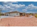 Spacious backyard with desert landscaping, featuring a covered patio perfect for outdoor entertaining at 4680 Peppertree St, Pahrump, NV 89061